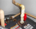 What causes the powdery crust on CPVC pipe connections at the water heater?